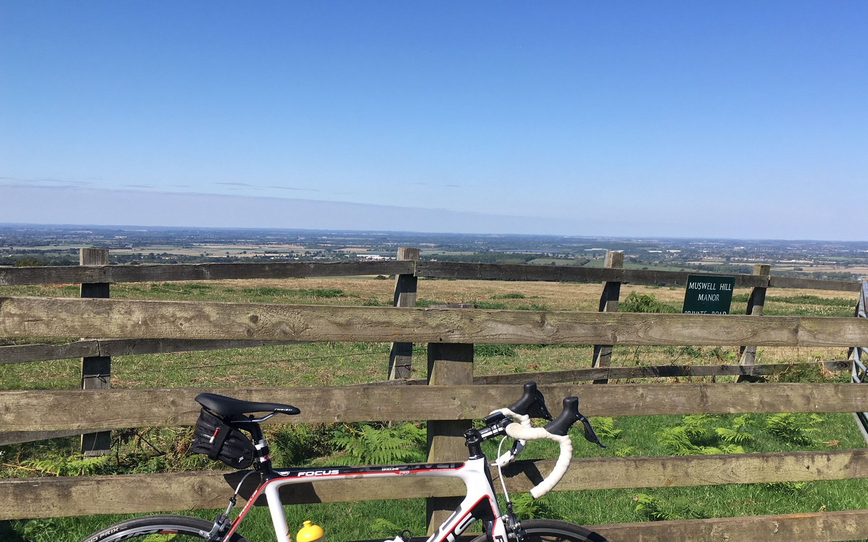 Picture of my bike and view from the top of Brill Hill